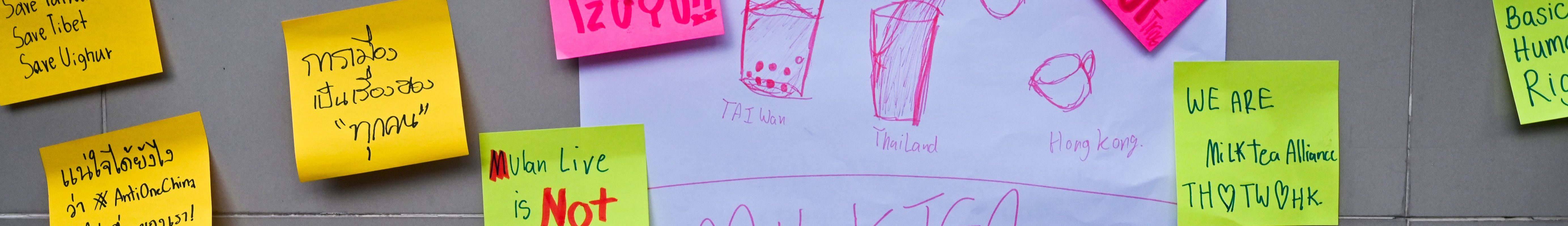 Sticker messages placed on a fence by Thai student demonstrators are seen during a Milk Tea Alliance pro-democracy protest outside the Chinese embassy in Bangkok on October 1, 2020. Some of the sticky-notes read, “Mulan Live is Not Mulan,” “Save Tzuyu!” “Respect Basic Human Rights,” and more.